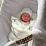 Kurt a rejoint le concours — aidez-le/la à gagner de superbes lots ! newborn, baby, sleeping, blanket, hat, bassinet, woven_handle, white, cozy, infant, swaddled, soft, cute, peaceful, resting, fabric, texture, indoor, portrait, child
