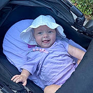 Ivy-Mai joined the competition — help win amazing prizes! baby, stroller, white_hat, lavender_clothing, smiling, tongue_out, pillow, outdoor, child, happy, person, cute, infant, hand, seat, blanket, sun_hat, playful, face, baby_accessory