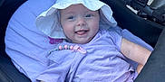 Ivy-Mai joined the competition — help win amazing prizes! baby, baby_accessory, blanket, child, cute, face, hand, happy, infant, lavender_clothing, outdoor, person, pillow, playful, seat, smiling, stroller, sun_hat, tongue_out, white_hat