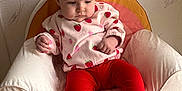 Elya participe au concours pour gagner de l'argent avec cette photo : baby, child, comfortable, cozy, cute, floor, indoor, infant, pink_clothing, plush_chair, portrait, rainbow_design, red_leggings, sitting, small_hands, soft_toys, strawberry_pattern, wall_texture, white_chair, young_child