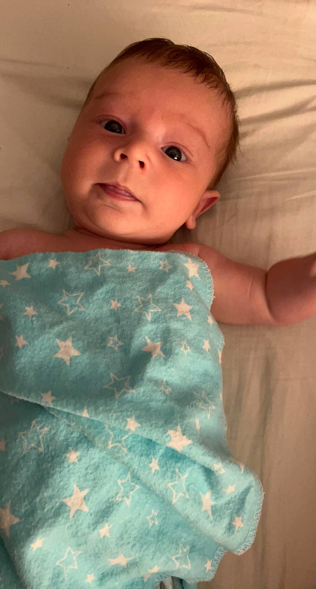 Waylon is registered to the contest to win money with this photo: baby, baby_toddler_clothing, bedding, cheek, child, comfort, eye, finger, hand, human_body, iris, linens, neck, nose, pattern, person, skin, sleeve, t_shirt, textile
