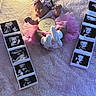 baby, infant, newborn, sleeping, portrait, pink_tutu, headband, bow, socks, blanket, ultrasound, photographs, one_month, indoor, soft_lighting, cute, resting, baby_clothing, celebration, flat_lay