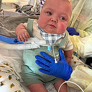 Zander joined the competition — help win amazing prizes! baby, child, medical_equipment, hospital, gloves, tubes, bib, overalls, bed, blanket, person, healthcare, infant, support, hand, medical_care, cute, indoor, patient, care