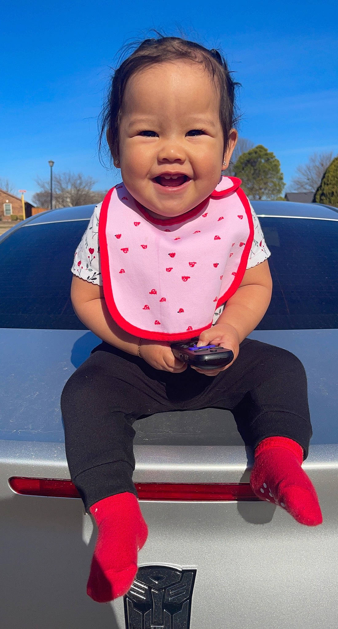 Aleila joined the competition — help win amazing prizes! baby_toddler_clothing, black, blue, car, cool, finger, happy, hood, joy, motor_vehicle, person, photograph, pink, product, skin, sky, sleeve, smile, standing, t_shirt
