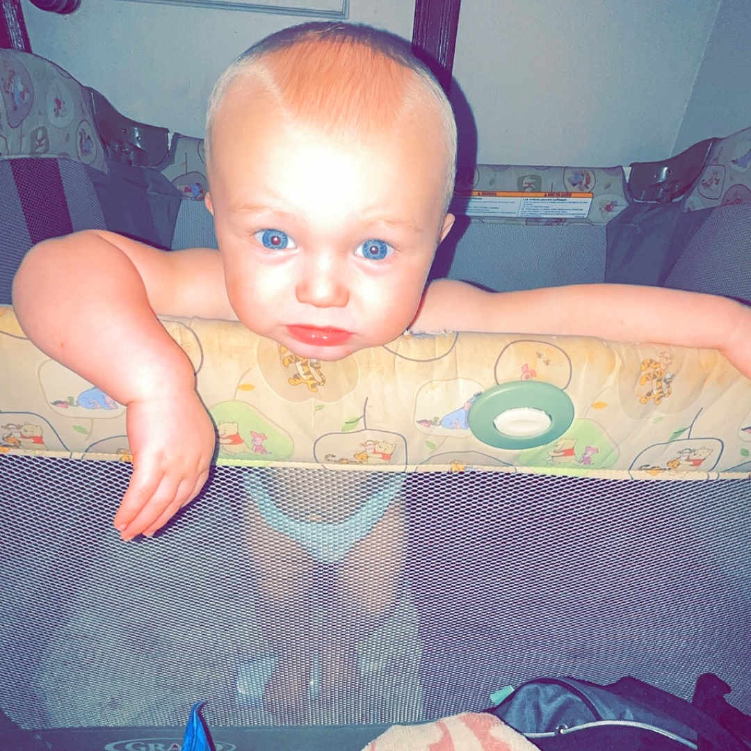 Jaxon joined the competition — help win amazing prizes! baby, bed, bedroom, bodypart, clothing, couch, crib, cushion, face, finger, furniture, hand, head, homedecor, indoors, infantbed, person, photography, portrait, t_shirt