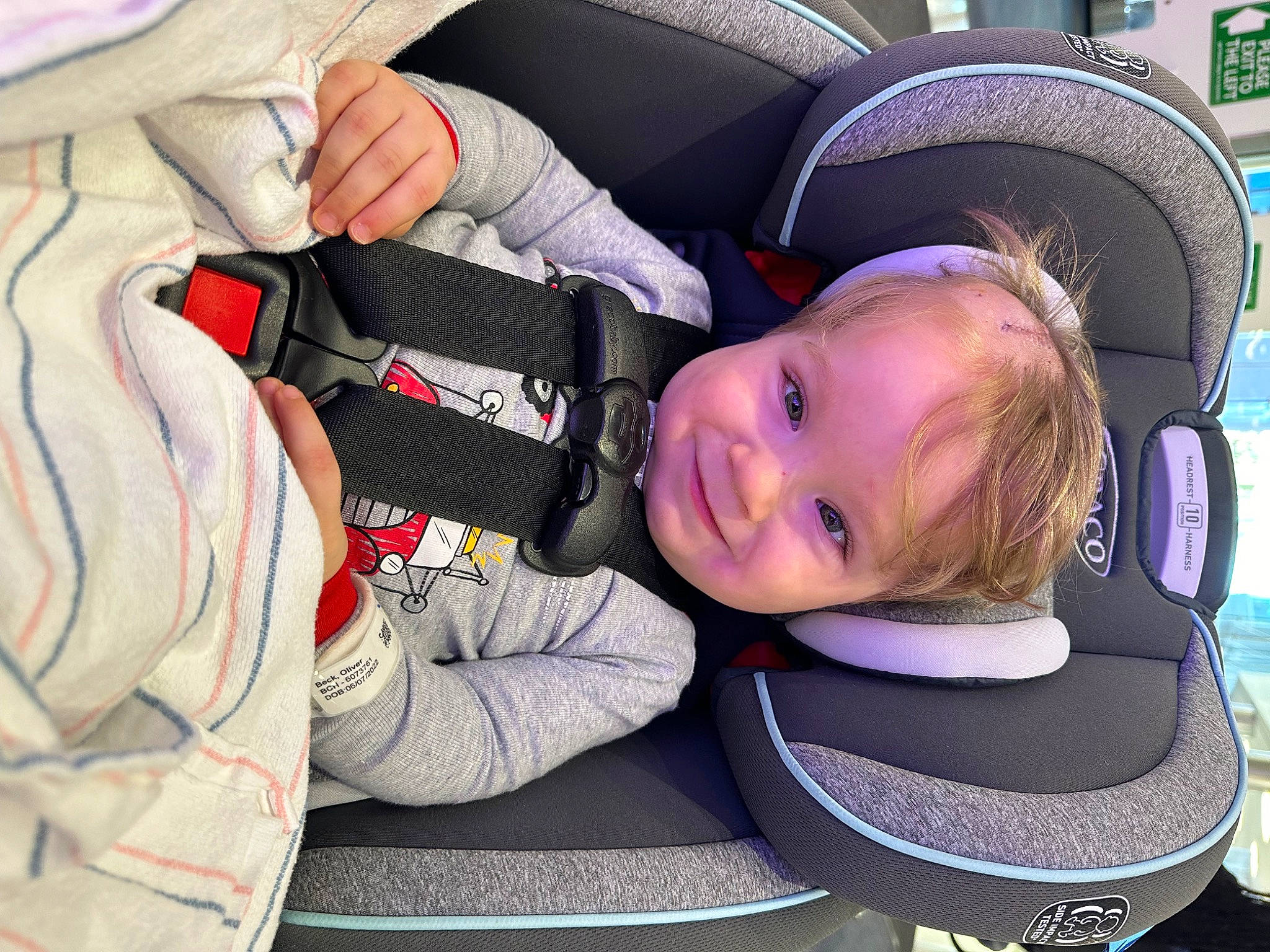Oliver is registered to the contest to win money with this photo: auto_part, automotive_design, automotive_wheel_system, baby_carriage, baby_in_car_seat, baby_products, baby_toddler_clothing, car_seat, carmine, child, comfort, electric_blue, face, fun, head_restraint, joy, luxury_vehicle, person, sitting, smile