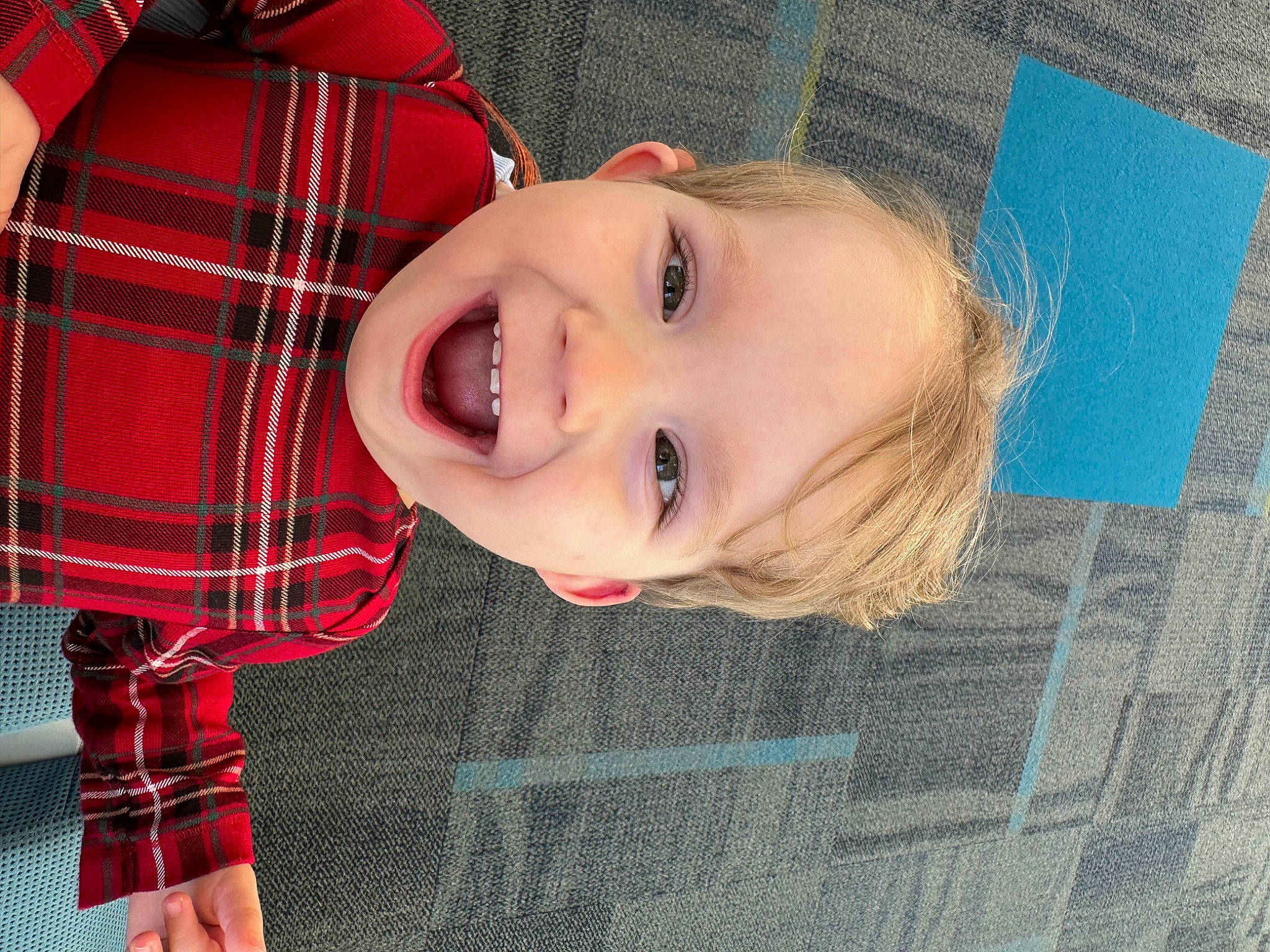 Oliver is registered to the contest to win money with this photo: baby_toddler_clothing, cheek, child, chin, collar, facial_expression, fun, happy, iris, lip, nose, pattern, person, plaid, red, skin, sleeve, smile, standing, tartan