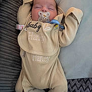 Harley joined the competition — help win amazing prizes! baby, beige, blanket, child, closeup, clothing, comfort, cozy, cushion, cute, face, indoors, infant, onesie, pacifier, peaceful, portrait, resting, sleeping, soft