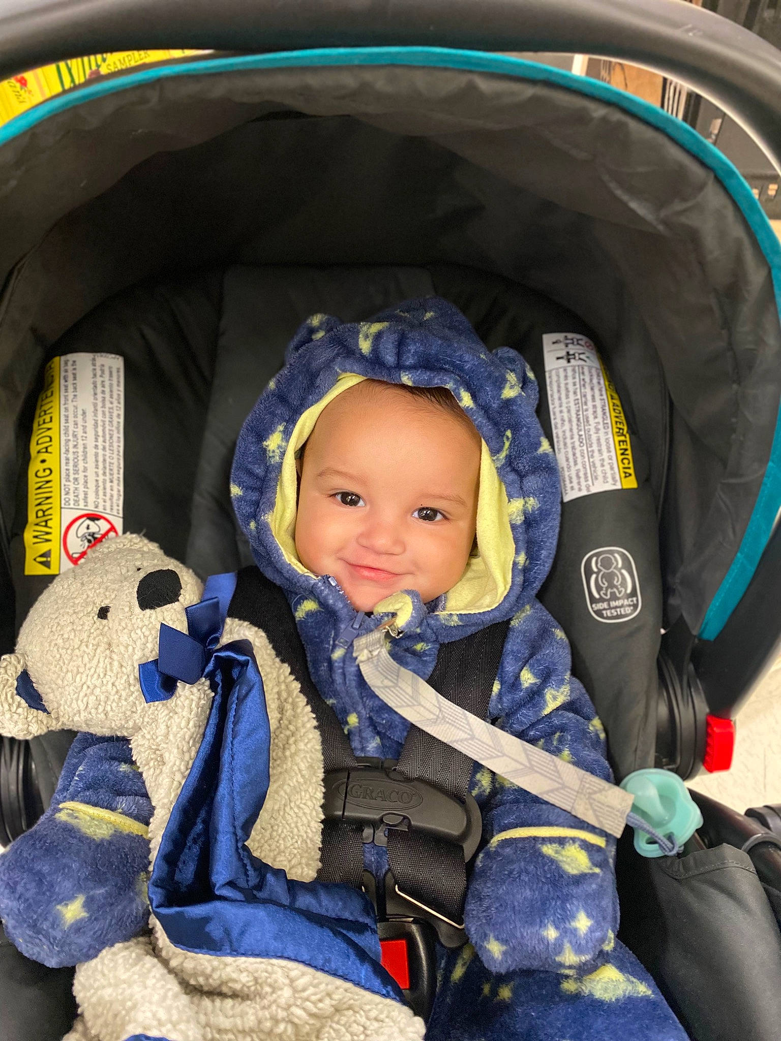 Sage is registered to the contest to win money with this photo: auto_part, baby, baby_carriage, baby_in_car_seat, baby_products, baby_toddler_clothing, car_seat, child, comfort, electric_blue, fun, joy, lap, leisure, person, product, sitting, smile, snapshot, steering_wheel