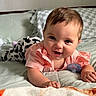 baby, bed, bedding, bedroom, blanket, blue_eyes, brown_hair, child, cozy, happy, indoors, infant, pacifier, photography, pillow, pink_clothing, plush_toy, portrait, sitting, smiling