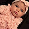 Mckenna is registered to the contest to win money with this photo: adorable, baby, black_background, blue_eyes, bow, child, close_up, eyes, face, fashion, headband, infant, knitted_clothing, lying_down, photography, pink_outfit, portrait, smiling, soft_lighting, textile