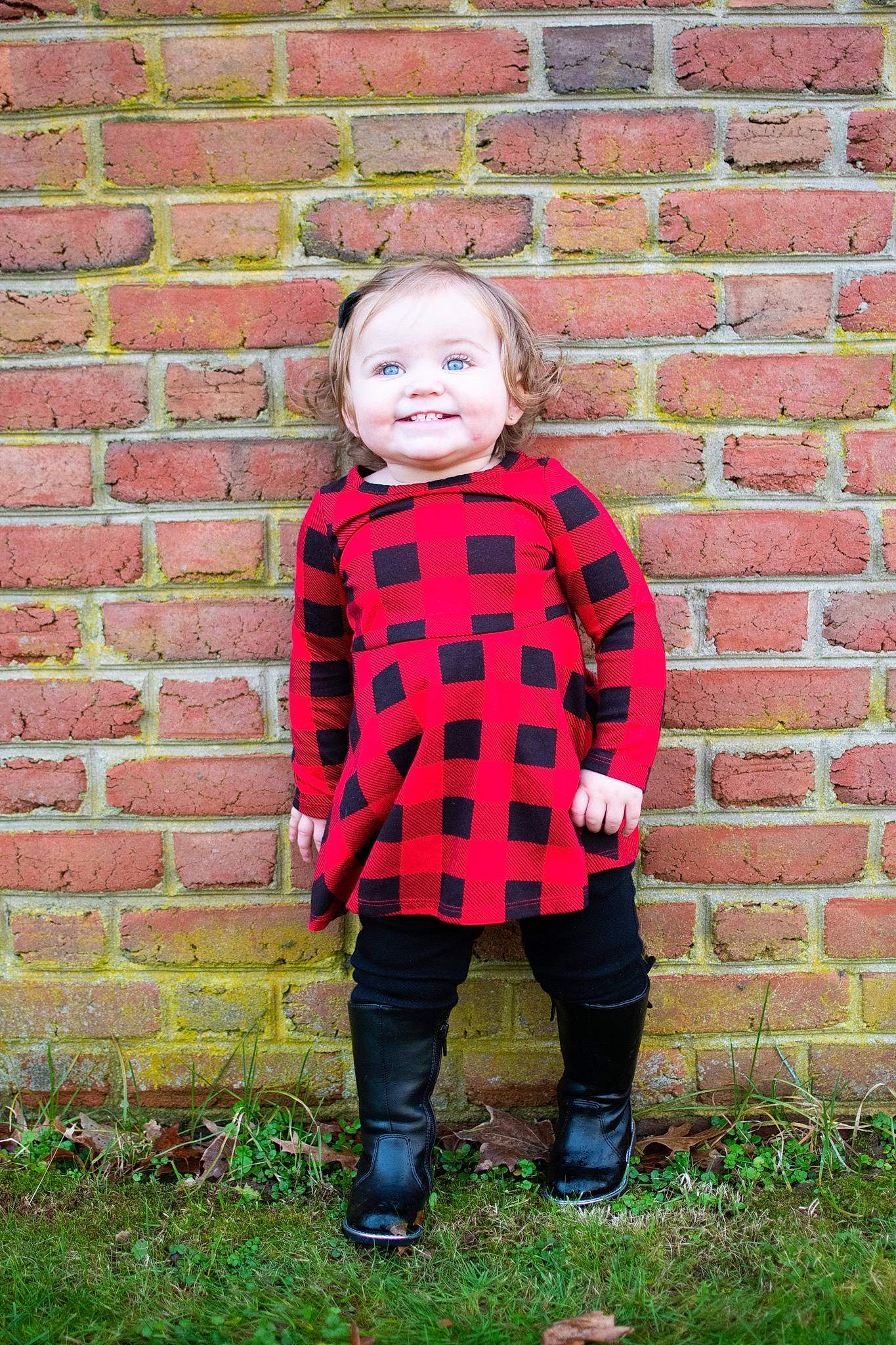 Lilliana Gail is registered to the contest to win money with this photo: brick, brickwork, child, eye, grass, happy, jacket, jeans, joy, pattern, people_in_nature, person, plaid, plant, shoe, sleeve, smile, standing, tartan, toddler