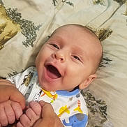 Dakota is registered to the contest to win money with this photo: animal_print, baby, bed, blanket, child, closeup, clothing, cute, elephant, face, giraffe, hands, happy, holding, infant, joyful, person, portrait, smiling, toddler