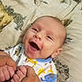 animal_print, baby, bed, blanket, child, closeup, clothing, cute, elephant, face, giraffe, hands, happy, holding, infant, joyful, person, portrait, smiling, toddler