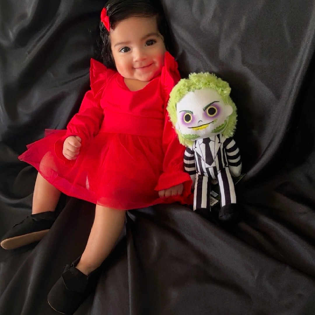 Alaïa is registered to the contest to win money with this photo: baby, bodypart, clothing, coat, costume, couch, cushion, doll, dress, face, finger, furniture, hand, head, homedecor, people, person, photography, portrait, toy
