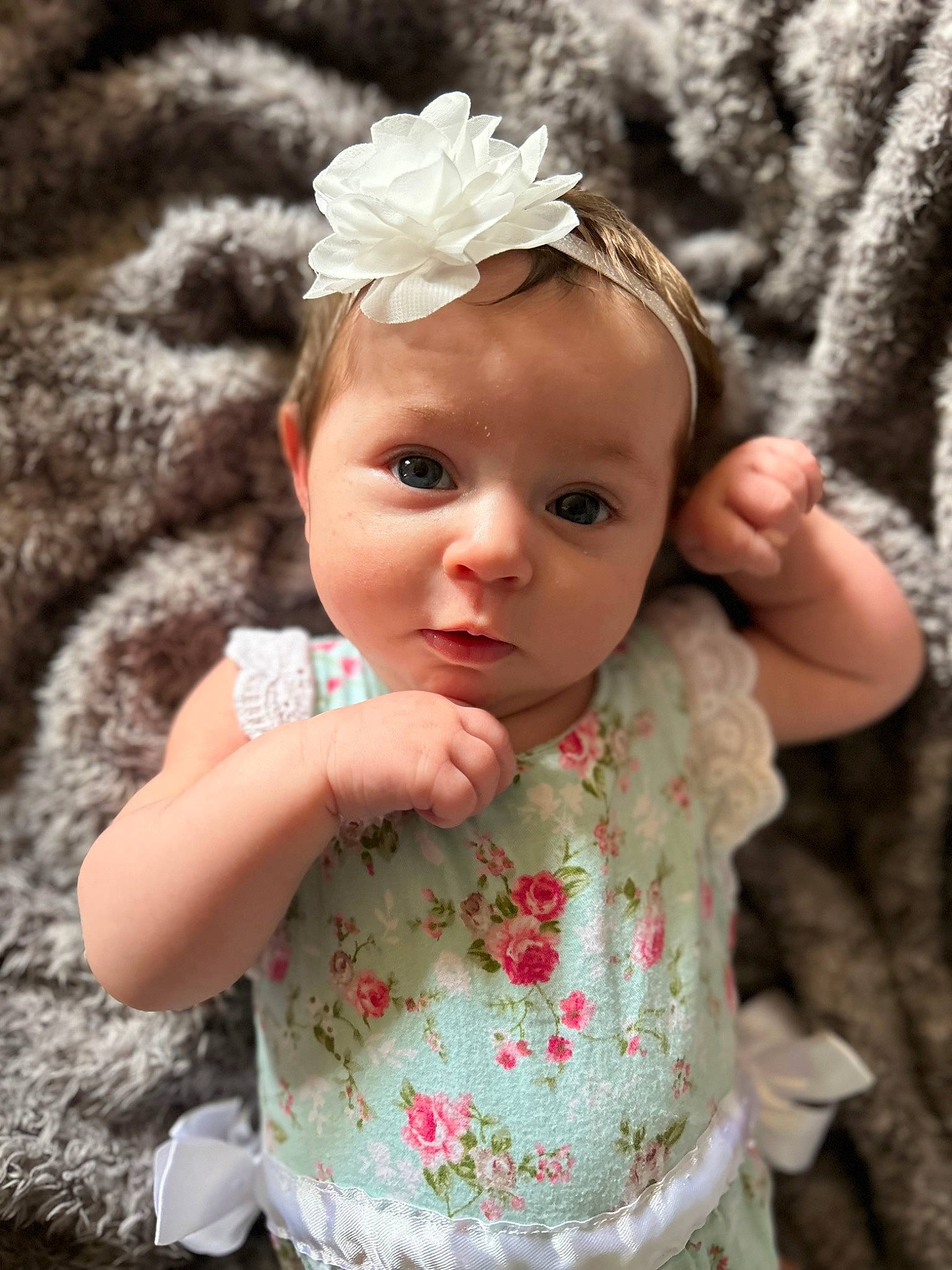 Emberlyn is registered to the contest to win money with this photo: baby, baby_toddler_clothing, dress, eye, flash_photography, flower, grass, hand, headgear, headpiece, iris, leaf, lip, organ, people_in_nature, person, petal, pink, plant, skin