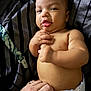 Jakai is registered to the contest to win money with this photo: baby, infant, diaper, hand, skin, face, expression, striped_fabric, blue_eyes, curious, chubby, fingers, nails, closeup, lying_down, indoor, soft_light, person, cute, toddler