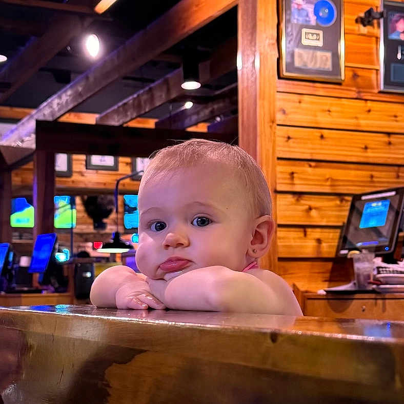 Bryn is registered to the contest to win money with this photo: baby, computerhardware, electronics, face, furniture, hardware, hardwood, head, indoors, interiordesign, monitor, person, photography, plywood, portrait, pub, screen, tub, urban, wood