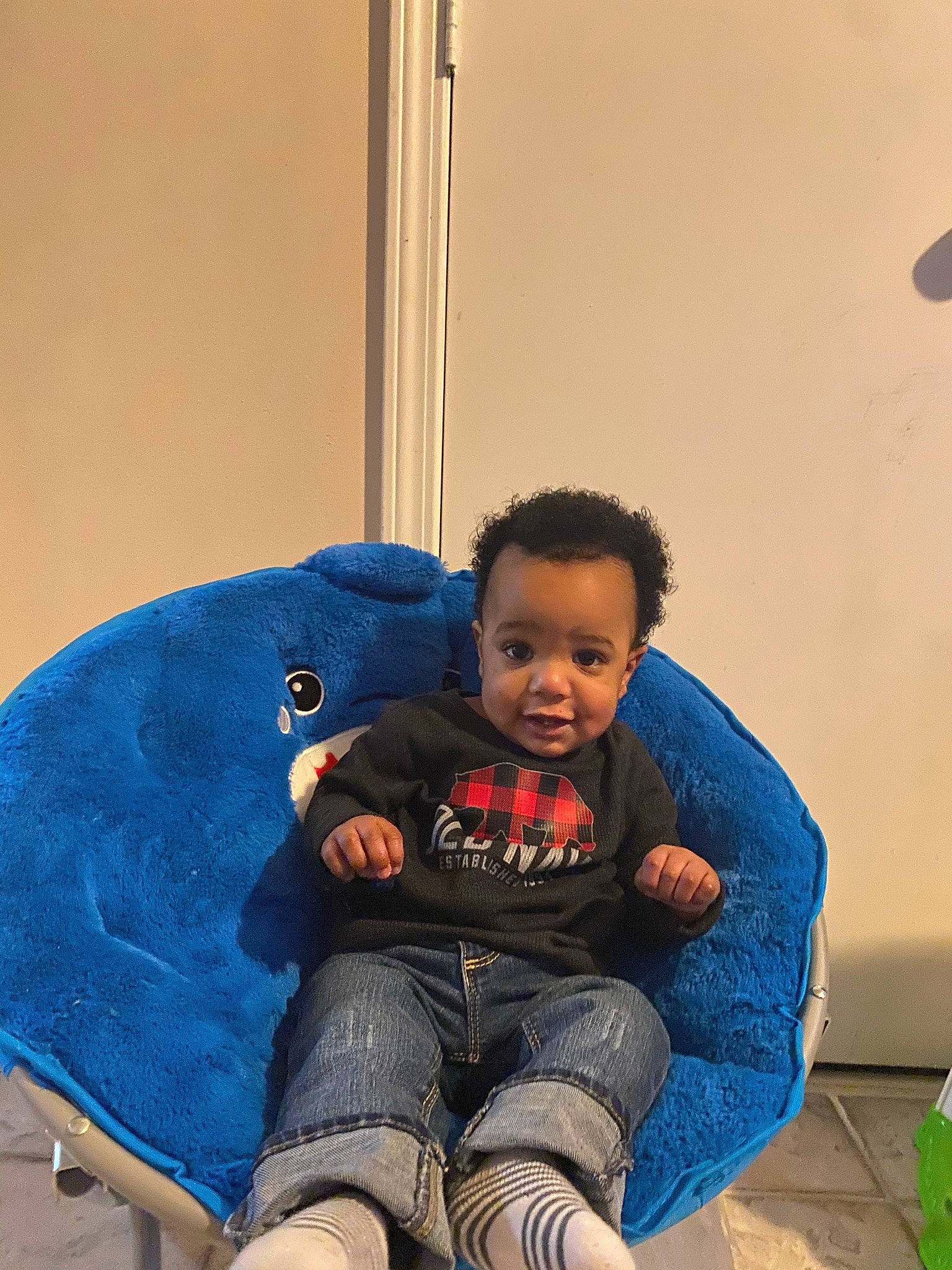 Azuri is registered to the contest to win money with this photo: baby, baby_toddler_clothing, child, comfort, denim, electric_blue, eye, face, flooring, fun, happy, head, human_leg, knee, lap, leisure, person, play, sitting, t_shirt