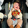 baby, car_seat, smile, turkey_bib, headband, striped_pants, knit_socks, happy, child, infant, seatbelt, cozy, cute, indoors, clothing, accessory, person, holiday_theme, footwear, portrait