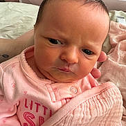 Sophia joined the competition — help win amazing prizes! baby, infant, face, pink_clothing, blanket, newborn, portrait, cute, child, swaddled, hand, skin, expression, indoors, closeup, person, soft, sleepwear, resting, newborn_clothes