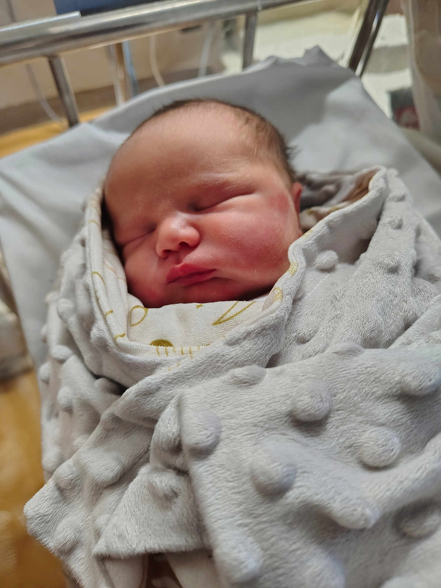 Aivar is registered to the contest to win money with this photo: newborn, baby, sleeping, blanket, hospital, bassinet, soft_texture, wrapped, infant, peaceful, face, head, indoors, closeup, person, cute, resting, newborn_baby, child, warm