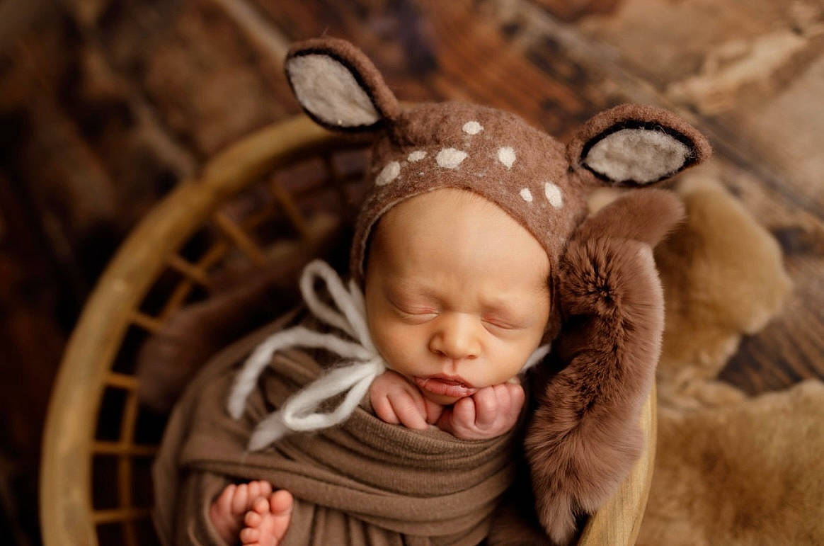 Kenneth joined the competition — help win amazing prizes! baby, baby_toddler_clothing, beanie, cap, child, costume_hat, ear, fashion_accessory, fur, grass, happy, headband, headgear, headpiece, knit_cap, linens, person, skin, toddler, wood