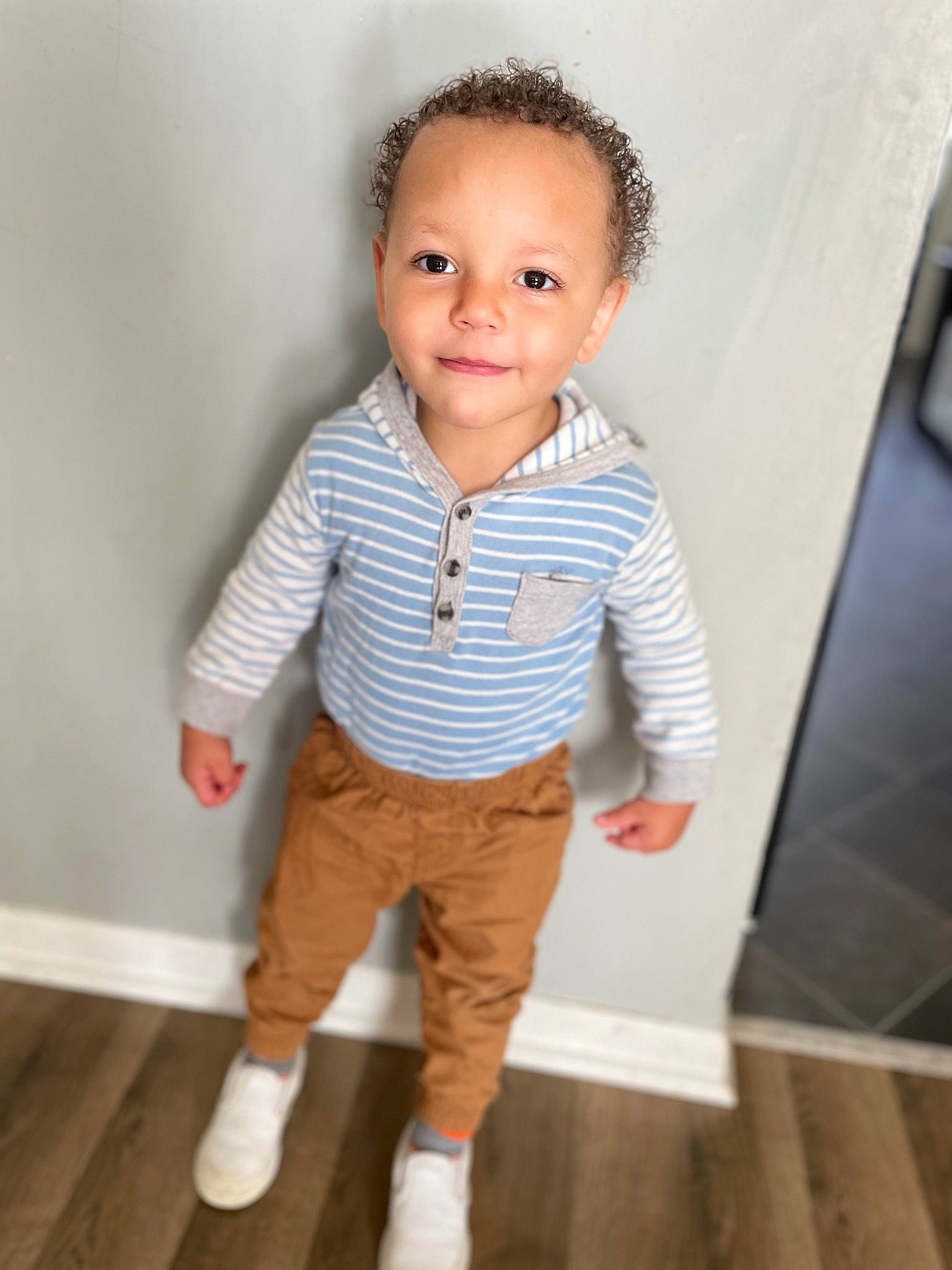 Oliver is registered to the contest to win money with this photo: arm, baby_toddler_clothing, cheek, collar, dress_shirt, face, flooring, hand, happy, head, human_body, iris, joy, neck, nose, outerwear, person, shoulder, skin, sleeve
