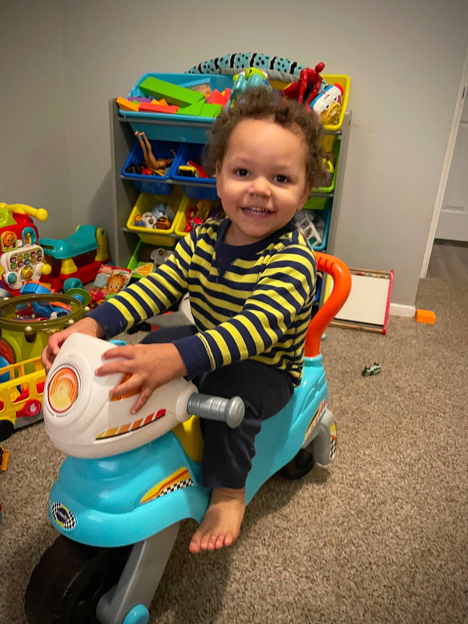 Oliver is registered to the contest to win money with this photo: baby, baby_playing_with_toys, baby_products, baby_toddler_clothing, baby_toys, chair, child, event, fun, happy, joy, person, plastic, play, riding_toy, room, sitting, smile, toddler, toy
