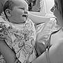 baby, infant, smiling, pajamas, teddy_bear_pattern, adult, woman, face, portrait, black_and_white, love, joy, home, indoor, holding, caring, happy, close_up, person, family