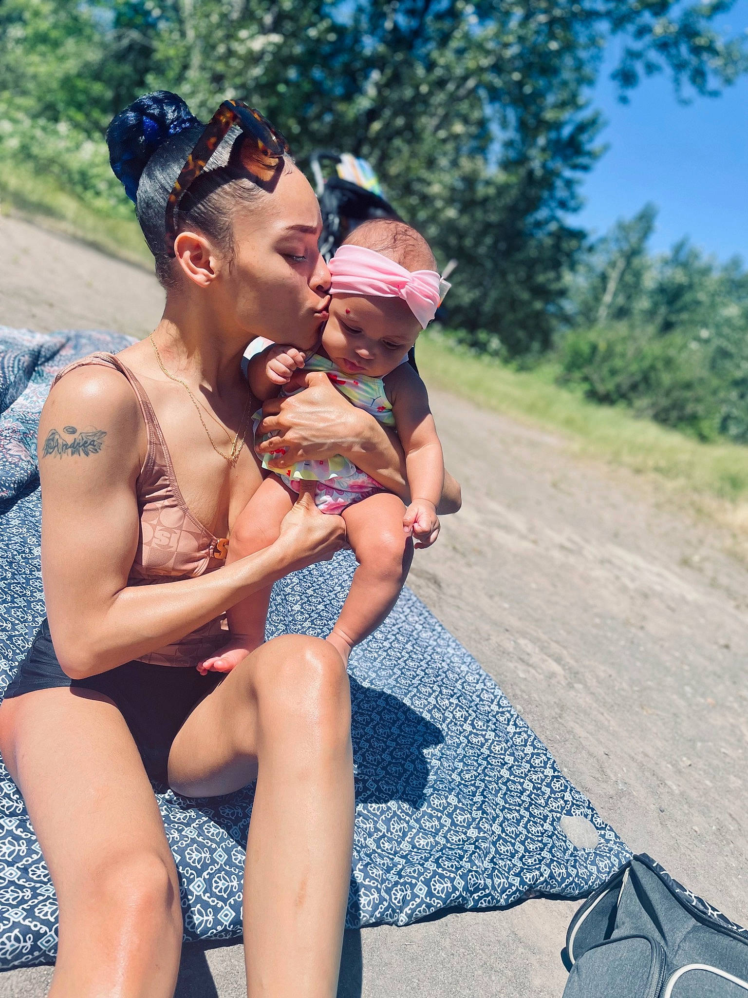 Andrea is registered to the contest to win money with this photo: baby, brassiere, event, eyewear, face, fun, happy, hat, headwear, leg, leisure, people_in_nature, people_on_beach, person, recreation, sand, swimsuit_top, swimwear, thigh, toddler