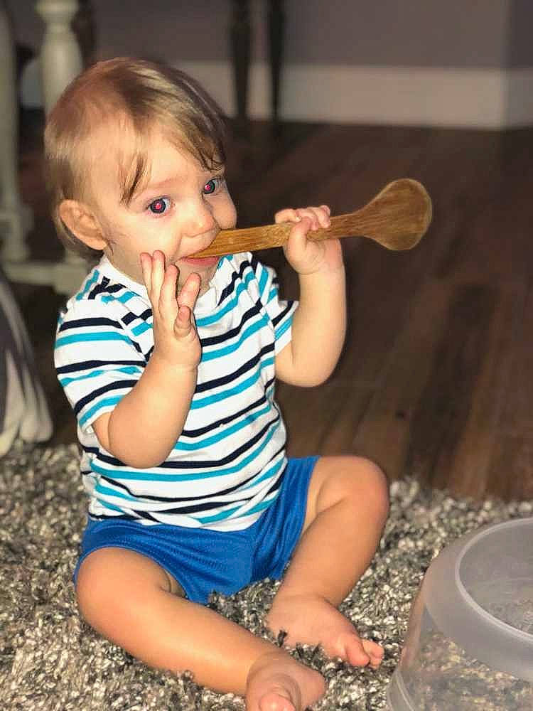 Riley is registered to the contest to win money with this photo: arm, child, eating, finger, girl, hand, leg, person, play, sitting, toddler