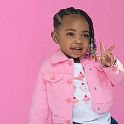 Delahni joined the competition — help win amazing prizes! child, girl, pink_jacket, denim_skirt, braided_hair, beads, peace_sign, smiling, portrait, studio, colorful, fashion, cute, happy, pink_background, toddler, casual_clothing, posing, young_child, playful