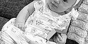 Isla joined the competition — help win amazing prizes! baby, infant, child, dress, headband, ring_box, ring, couch, textured_fabric, sock, cute, smiling, portrait, indoors, monochrome, black_and_white, hand, sitting, toy, blanket
