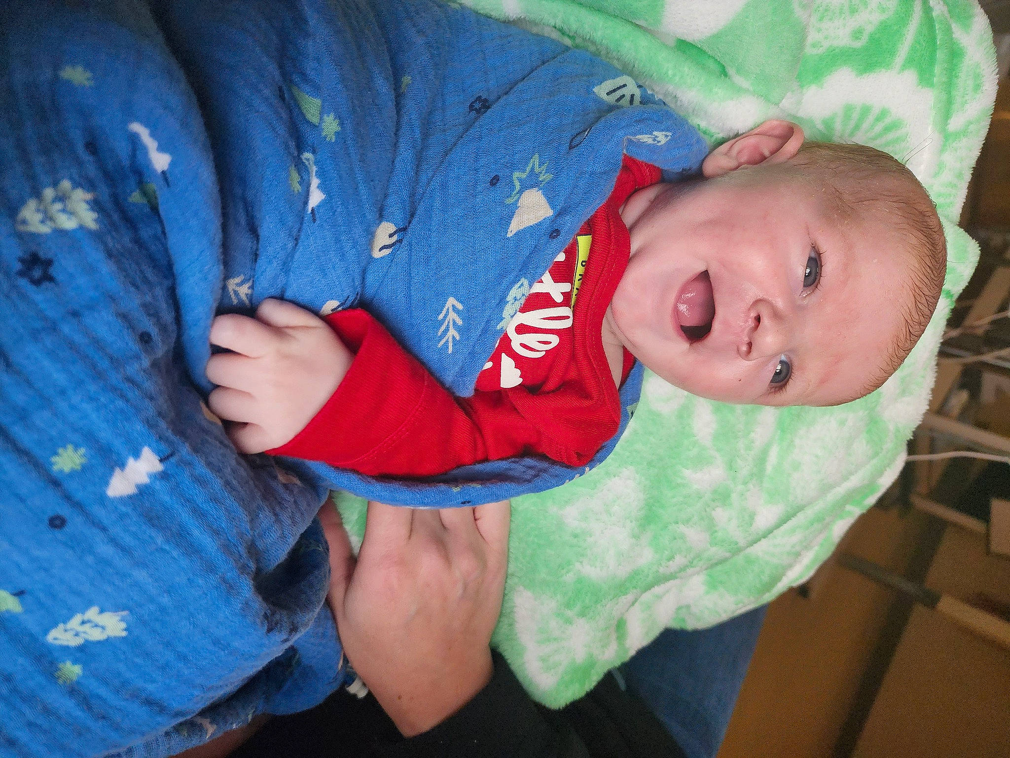 Bryce is registered to the contest to win money with this photo: baby, baby_toddler_clothing, child, comfort, elbow, electric_blue, fun, lap, pattern, person, sitting, sleeve, smile, toddler, tree