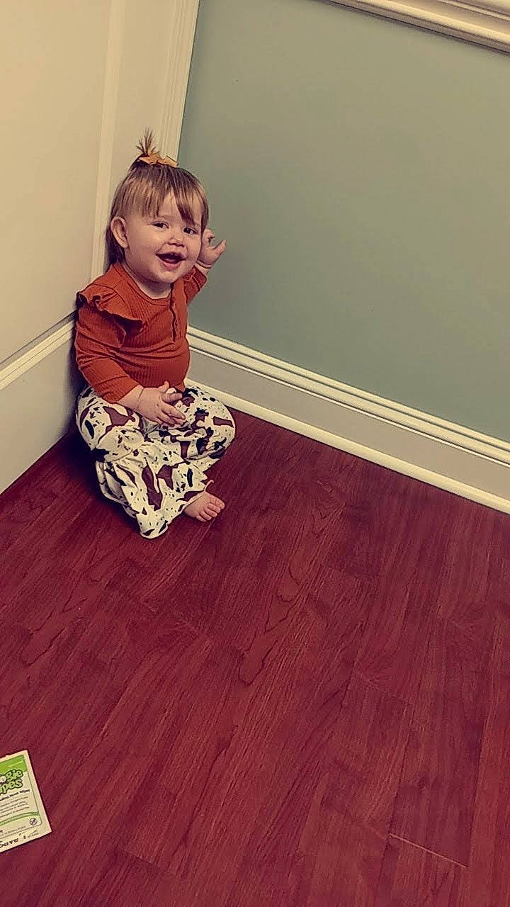 Ella joined the competition — help win amazing prizes! baby_toddler_clothing, child, comfort, floor, flooring, hardwood, human_leg, joy, laminate_flooring, pattern, person, plaster, plywood, room, sitting, smile, stairs, toddler, varnish, wood