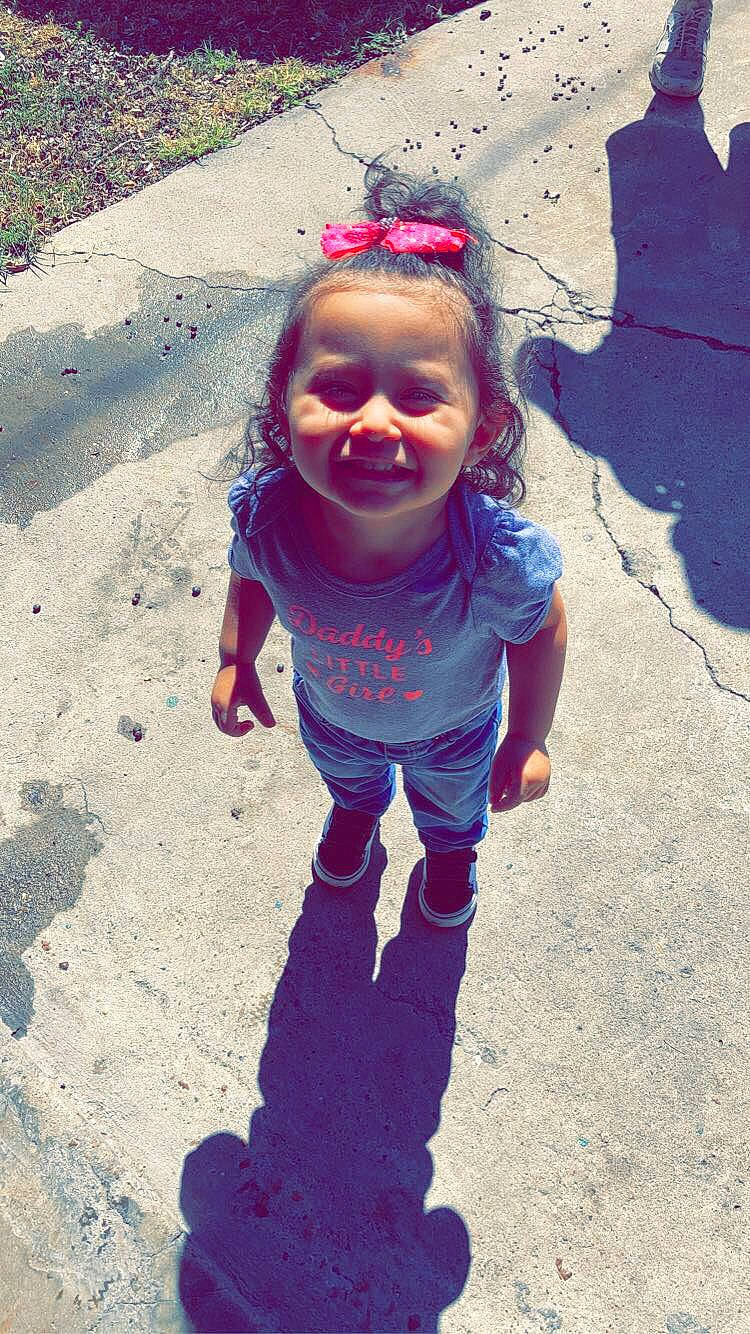 Lilyana is registered to the contest to win money with this photo: asphalt, baby_toddler_clothing, cool, electric_blue, eye, face, fun, gesture, grass, happy, joy, leisure, people_in_nature, person, photograph, pink, public_space, purple, smile, snapshot