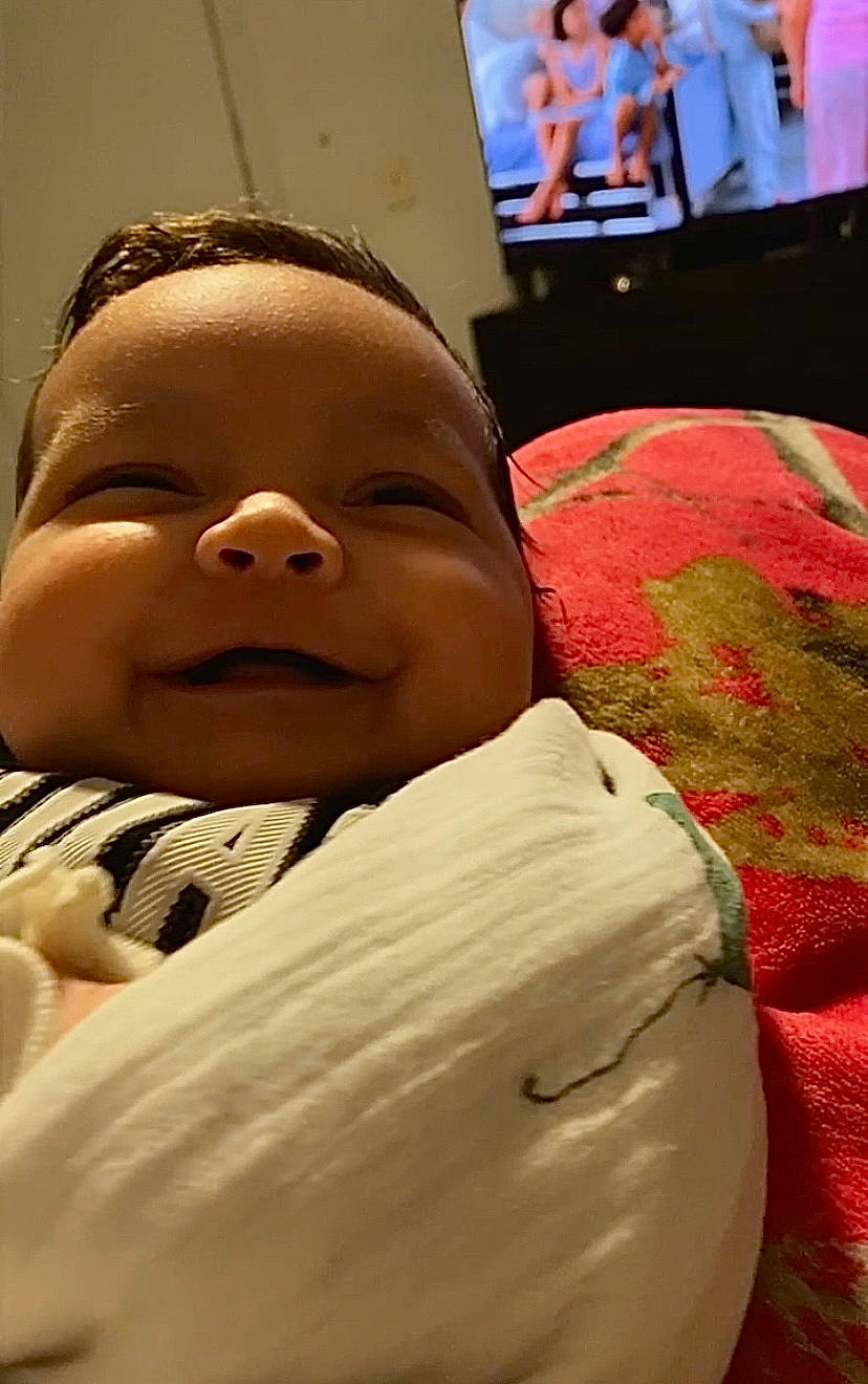 Alexander is registered to the contest to win money with this photo: baby, bed, bedding, bedtime, cheek, child, comfort, fun, happy, laugh, linens, mammal, mouth, nose, person, room, skin, smile, television, textile