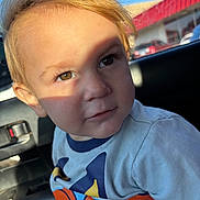 James joined the competition — help win amazing prizes! child, toddler, face, portrait, car_interior, sunlight, shadow, curious, blond_hair, hazel_eyes, clothing, casual, seat, window, daylight, closeup, person, young_child, indoor, candid