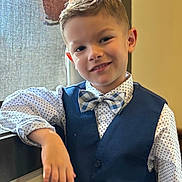 David joined the competition — help win amazing prizes! child, boy, smile, face, portrait, bow_tie, vest, shirt, polka_dot, casual_pose, indoor, window, curtain, young, confident, happy, fashion, person, hair, light