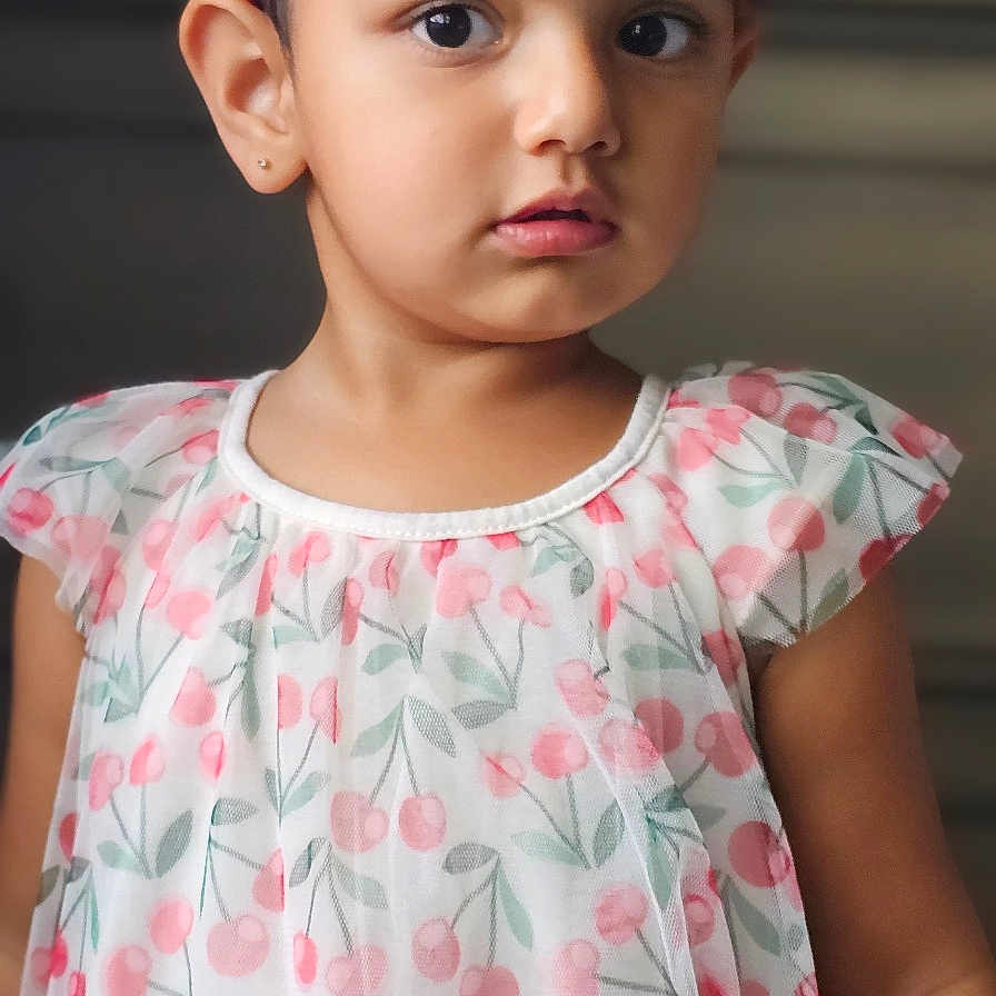 Kaeya joined the competition — help win amazing prizes! child, girl, toddler, portrait, standing, dress, floral_dress, bow, headband, pink, white, cherries, patterned_clothing, indoors, face, eyes, serious_expression, earrings, fashion, photography