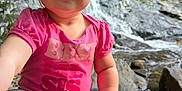 Madelyn joined the competition — help win amazing prizes! toddler, child, pink_shirt, best_sis_text, leggings, waterfall, rocks, outdoor, nature, smile, sitting, playful_hair_clip, curious, sunlight, water, forest, happy, cute, person, casual_clothing