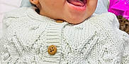 Tiana joined the competition — help win amazing prizes! baby, child, close_up, cozy, cute, expression, face, happy, indoor, infant, joy, knitted_sweater, laughing, portrait, smiling, soft_blanket, warm_clothing, white_sweater, wooden_buttons, young_child