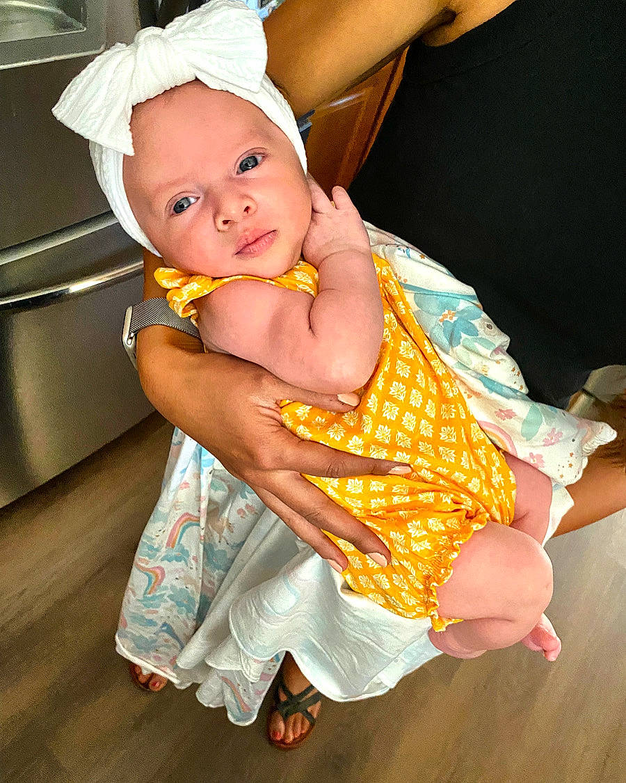 Josephine joined the competition — help win amazing prizes! arm, baby, baby_toddler_clothing, child, day_dress, dress, event, fashion_accessory, finger, flooring, fun, gesture, happy, human_leg, pattern, person, sandal, skin, smile, thumb