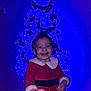 Shelby participe au concours pour gagner de l'argent avec cette photo : child, toddler, smile, christmas_tree, holiday, festive_clothing, red_dress, blue_lights, indoor, decoration, happy, cute, celebration, portrait, person, christmas, festivity, holiday_season, joy, smiling