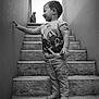 toddler, child, stairs, barefoot, tshirt, smiling, concrete, wall, outdoor, person, young_child, side_view, casual_clothing, monochrome, portrait, happy, playful, short_hair, small_person, daylight