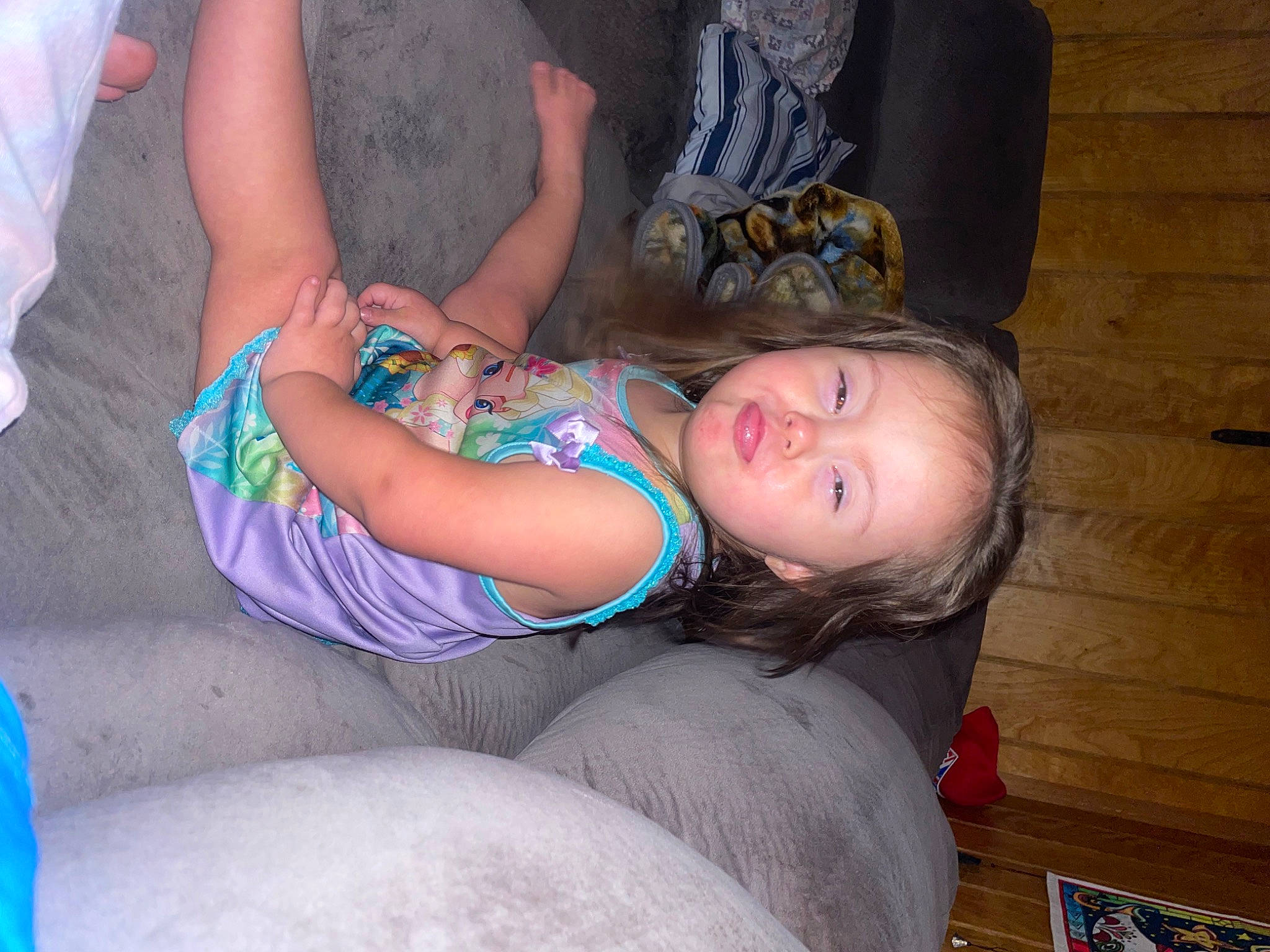 Carmella is registered to the contest to win money with this photo: abdomen, blond, chest, child, comfort, electric_blue, flooring, foot, fun, hat, human_leg, joint, knee, lap, leg, mouth, person, sitting, thigh, toddler