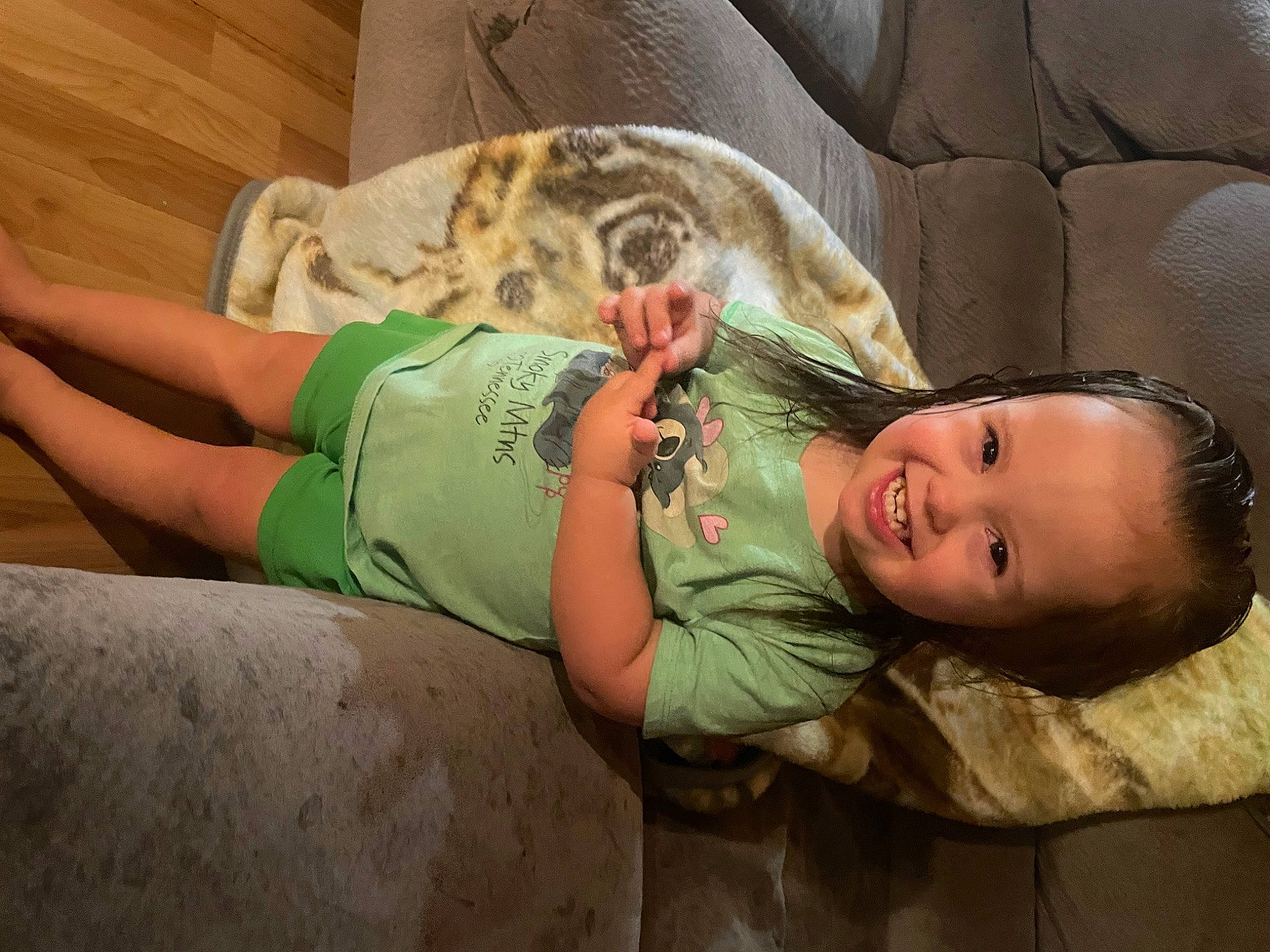 Carmella is registered to the contest to win money with this photo: baby, child, comfort, companion_dog, couch, felidae, foot, fun, happy, human_leg, joy, knee, leg, linens, person, sitting, skin, smile, t_shirt, thigh