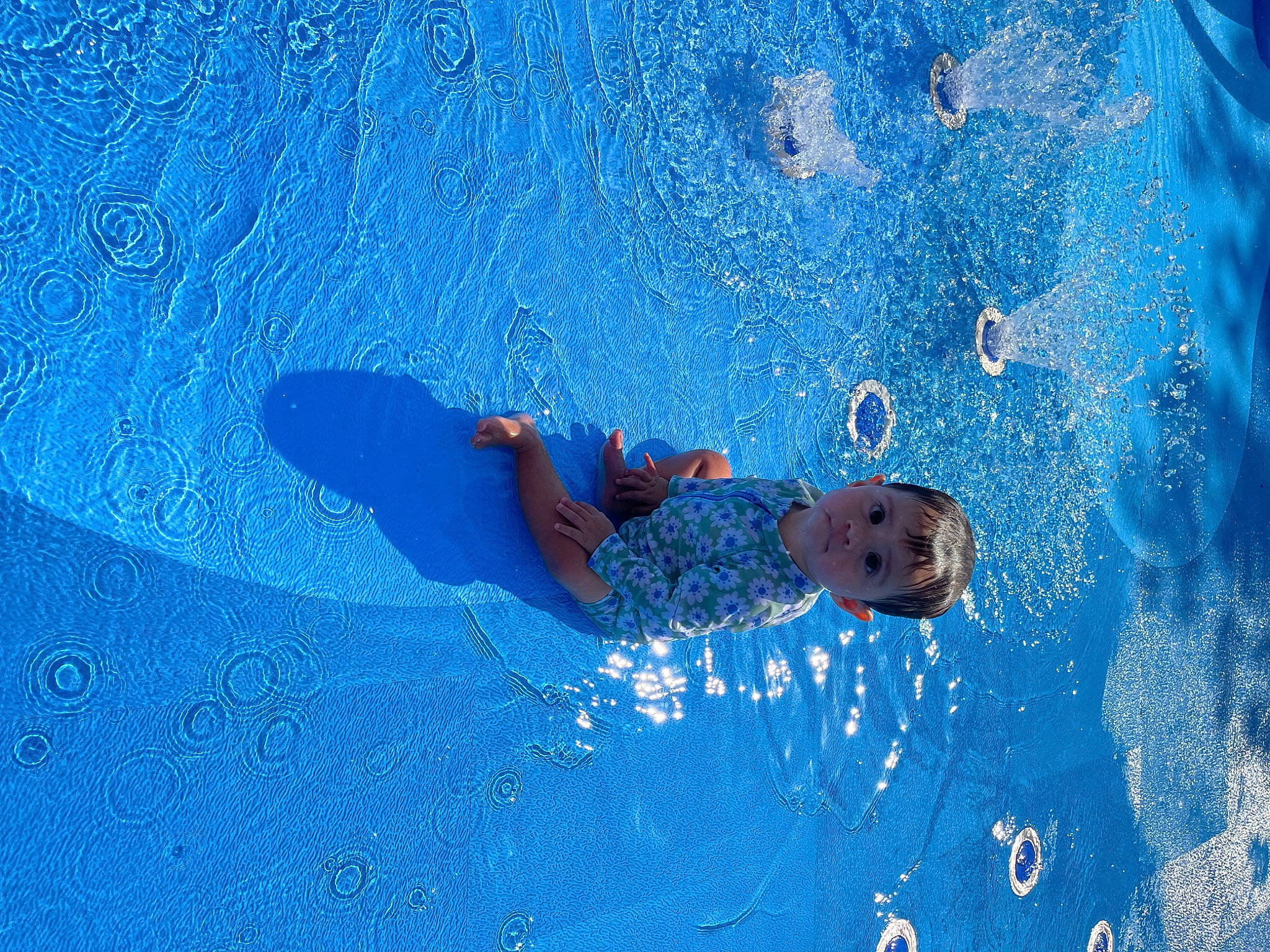 Rebeka is registered to the contest to win money with this photo: azure, child, circle, concrete, electric_blue, fun, happy, leisure, paint, pattern, person, recreation, rectangle, shadow, smile, toddler, water