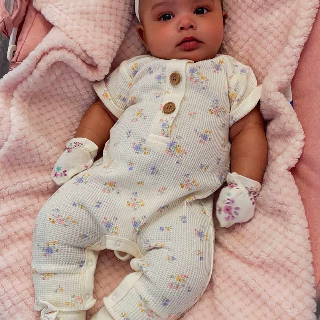 Kit is registered to the contest to win money with this photo: baby, bed, blanket, clothing, crib, cushion, face, furniture, hat, head, homedecor, hosiery, infantbed, newborn, person, photography, portrait, quilt, sock, toy